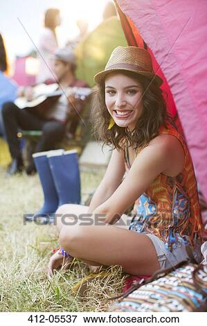 Portrait of smiling woman sitting at tent at music festival View Large Photo Image Stock Photo - Portrait of smiling woman sitting at tent at music festival. Fotosearch