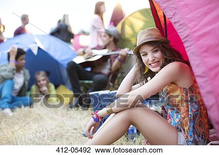 Portrait of woman sitting at front of tent at music festival View Large Photo Image Stock Image - Portrait of woman sitting at front of tent at music festival. Fotosearch