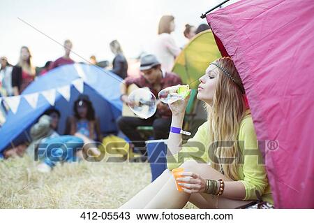 Woman blowing bubbles from tent at music festival View Large Photo Image Stock Image - Woman blowing bubbles from tent at music festival. Fotosearch