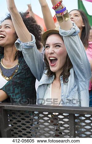Woman cheering at music festival View Large Photo Image Stock Photography - Woman cheering at music festival. Fotosearch