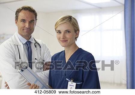 Stock Photo - Doctor and nurse smiling in hospital. Fotosearch