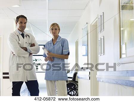 Doctor and nurse standing in hospital hallway View Large Photo Image Stock Image - Doctor and nurse standing in hospital hallway. Fotosearch