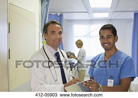 Doctor and nurse talking in hospital room View Large Photo Image Stock Image - Doctor and nurse talking in hospital room. Fotosearch