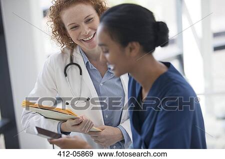 Doctor and nurse talking in hospital View Large Photo Image Stock Photo - Doctor and nurse talking in hospital. Fotosearch