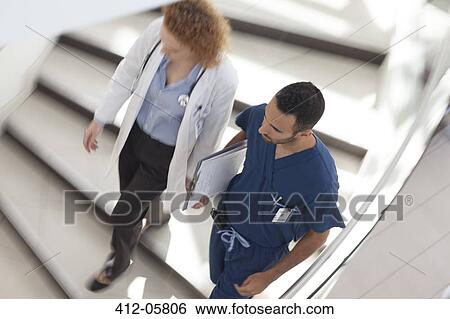 Doctor and nurse walking on hospital steps View Large Photo Image Stock Photograph - Doctor and nurse walking on hospital steps. Fotosearch