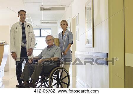 Doctor and nurse with older patient in hospital View Large Photo Image Stock Image - Doctor and nurse with older patient in hospital. Fotosearch