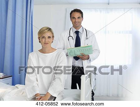 Doctor and patient smiling in hospital room View Large Photo Image Stock Image - Doctor and patient smiling in hospital room. Fotosearch