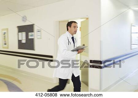Stock Photo - Doctor rushing in hospital hallway. Fotosearch