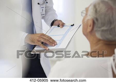 Doctor showing medical chart to patient in hospital room View Large Photo Image Stock Photography - Doctor showing medical chart to patient in hospital room. Fotosearch