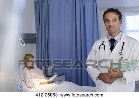 Stock Image - Doctor smiling in hospital room. Fotosearch