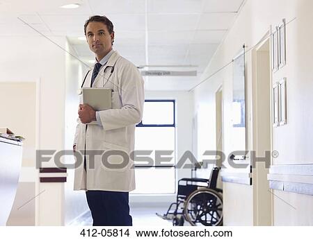 Doctor standing in hospital hallway View Large Photo Image Picture - Doctor standing in hospital hallway. Fotosearch