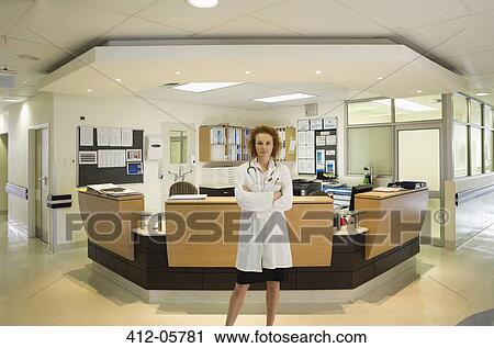 Doctor standing in hospital hallway View Large Photo Image Stock Image - Doctor standing in hospital hallway. Fotosearch
