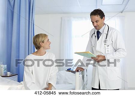 Doctor talking with patient in hospital room View Large Photo Image Stock Photography - Doctor talking with patient in hospital room. Fotosearch