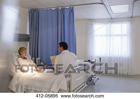 Doctor talking with patient in hospital room View Large Photo Image Stock Photography - Doctor talking with patient in hospital room. Fotosearch