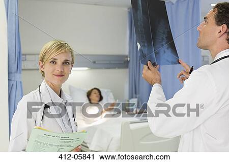 Doctors examining x-rays in hospital room View Large Photo Image Stock Image - Doctors examining x-rays in hospital room. Fotosearch