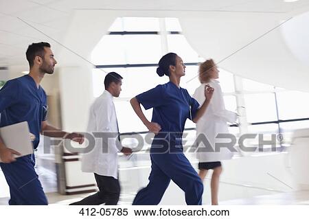 Hospital staff running down hallway View Large Photo Image Stock Photography - Hospital staff running down hallway. Fotosearch