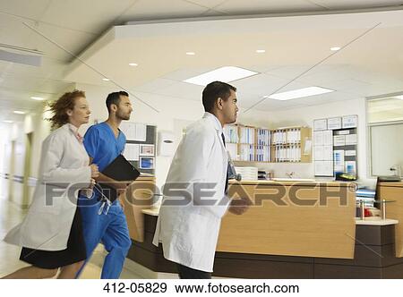 Hospital staff rushing down hallway View Large Photo Image Stock Photo - Hospital staff rushing down hallway. Fotosearch