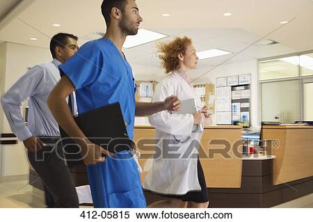 Hospital staff rushing down hallway View Large Photo Image Stock Photography - Hospital staff rushing down hallway. Fotosearch