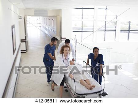 Hospital staff rushing patient to hospital room View Large Photo Image Stock Image - Hospital staff rushing patient to hospital room. Fotosearch