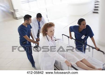 Hospital staff rushing patient to operating room View Large Photo Image Stock Image - Hospital staff rushing patient to operating room. Fotosearch