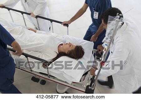 Stock Photo - Hospital staff rushing patient to operating room. Fotosearch