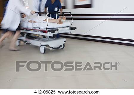 Stock Photography - Hospital staff rushing patient to operating room. Fotosearch