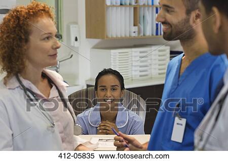 Hospital staff talking at front desk View Large Photo Image Stock Photography - Hospital staff talking at front desk. Fotosearch