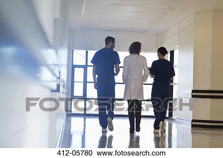 Hospital staff talking in hallway View Large Photo Image Stock Image - Hospital staff talking in hallway. Fotosearch