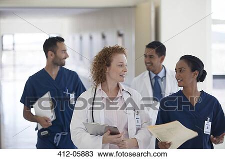 Hospital staff talking in hallway View Large Photo Image Stock Image - Hospital staff talking in hallway. Fotosearch