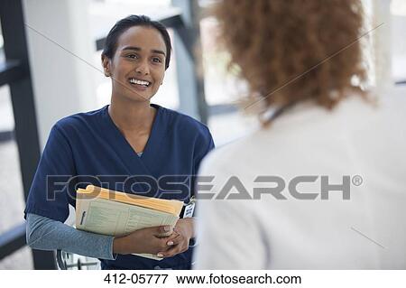 Nurse and doctor talking in hospital View Large Photo Image Stock Photo - Nurse and doctor talking in hospital. Fotosearch