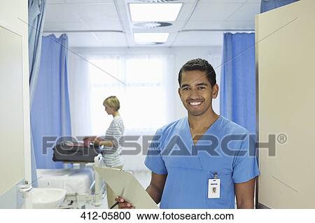 Nurse holding clipboard in hospital room View Large Photo Image Stock Image - Nurse holding clipboard in hospital room. Fotosearch