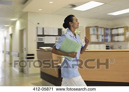 Nurse rushing in hospital hallway View Large Photo Image Stock Image - Nurse rushing in hospital hallway. Fotosearch