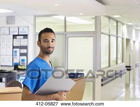 Nurse smiling in hospital hallway View Large Photo Image Stock Photo - Nurse smiling in hospital hallway. Fotosearch