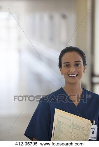 Nurse smiling in hospital hallway View Large Photo Image Stock Photography - Nurse smiling in hospital hallway. Fotosearch