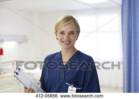 Nurse smiling in hospital room View Large Photo Image Stock Photograph - Nurse smiling in hospital room. Fotosearch