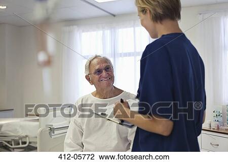 Nurse talking with older patient in hospital View Large Photo Image Stock Image - Nurse talking with older patient in hospital. Fotosearch