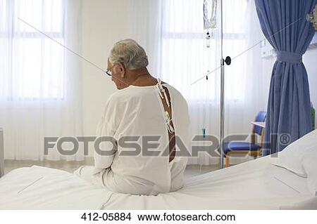 Older patient wearing gown in hospital room View Large Photo Image Picture - Older patient wearing gown in hospital room. Fotosearch