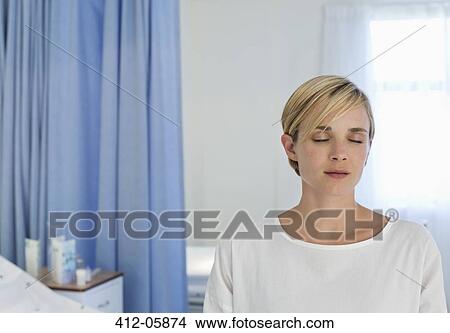 Patient sitting on bed in hospital room View Large Photo Image Picture - Patient sitting on bed in hospital room. Fotosearch