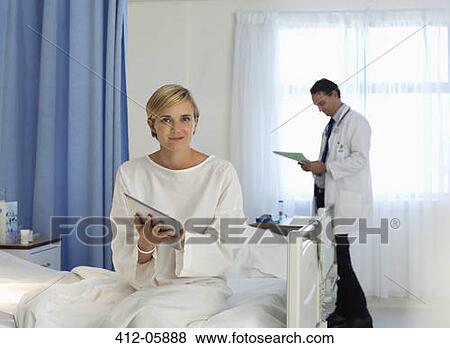 Patient using tablet computer in hospital room View Large Photo Image Stock Photo - Patient using tablet computer in hospital room. Fotosearch