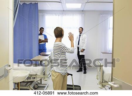Patient waving to doctor in hospital room View Large Photo Image Stock Image - Patient waving to doctor in hospital room. Fotosearch