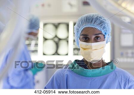 Picture - Surgeon standing in operating room. Fotosearch