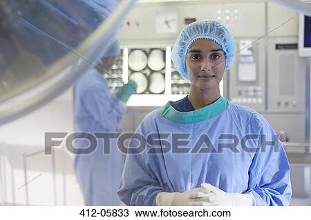 Surgeon standing in operating room View Large Photo Image Stock Image - Surgeon standing in operating room. Fotosearch