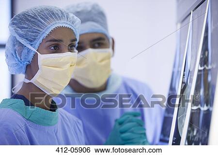 Surgeons examining x-rays in hospital room View Large Photo Image Stock Photograph - Surgeons examining x-rays in hospital room. Fotosearch