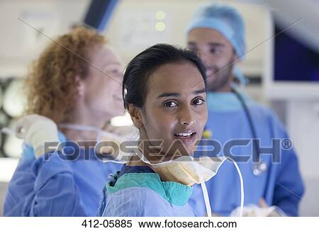 Surgeons standing operating room View Large Photo Image Stock Photography - Surgeons standing operating room. Fotosearch
