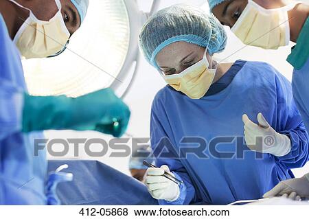 Surgeons working in operating room View Large Photo Image Stock Photo - Surgeons working in operating room. Fotosearch