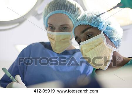 Surgeons working in operating room View Large Photo Image Stock Photo - Surgeons working in operating room. Fotosearch