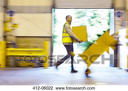 Blurred view of workers carrying boxes in warehouse View Large Photo Image Stock Image - Blurred view of workers carrying boxes in warehouse. Fotosearch