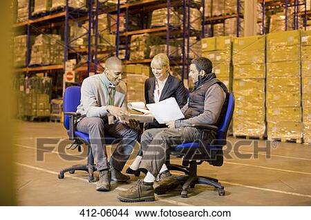 Business people talking in warehouse View Large Photo Image Picture - Business people talking in warehouse. Fotosearch