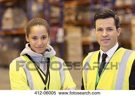 Businessman and worker smiling in warehouse View Large Photo Image Stock Photography - Businessman and worker smiling in warehouse. Fotosearch