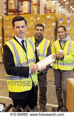Businessman and workers in warehouse View Large Photo Image Stock Image - Businessman and workers in warehouse. Fotosearch